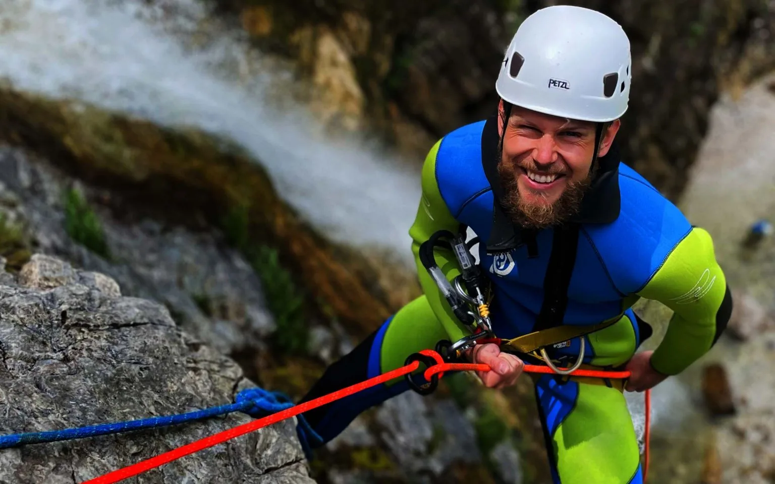 Canyoner descending beside a waterfall in Slovenia